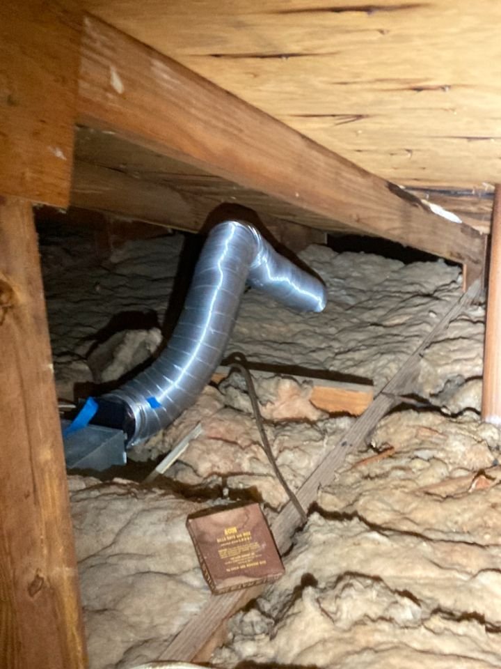 Bathroom vent improperly terminating in the attic.